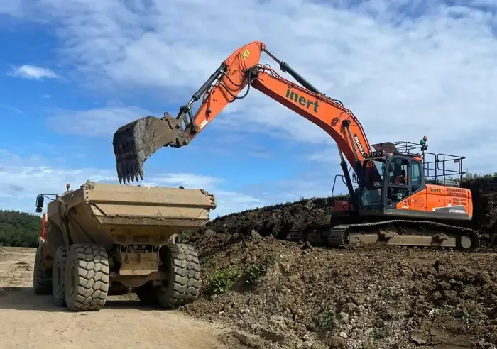 360 excavator loading an articulated dump truck on a groundworks site used for plant training